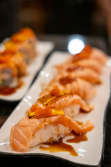 Set of Salmon aburi sushi with saikyo sauce on plate
