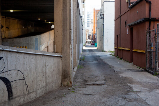Brick paved alleyway in urban downtown location by Parking Garage