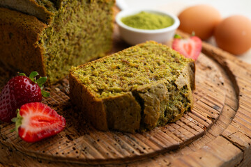 Japanese matcha tea cake decorated with strawberries. Traditional Japanese sweet cake recipe.