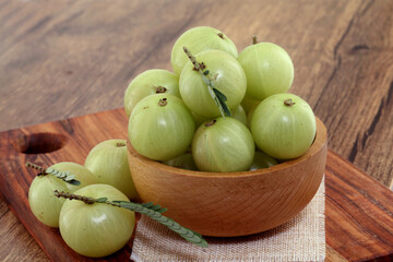  Fresh gooseberries in wooden bowl,Close up 