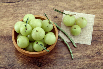  Fresh gooseberries in wooden bowl,Close up 