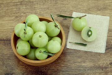  Fresh gooseberries in wooden bowl,Close up 