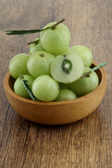  Fresh gooseberries in wooden bowl,Close up 