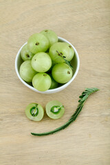  Fresh gooseberries in wooden bowl,Close up 