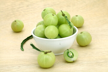 Fresh gooseberries (Amla)in white bowl