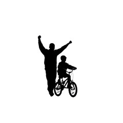 Fototapeta premium Silhouette of Father and Son Celebrating a Successful Bike Ride