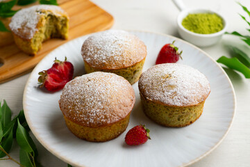 Japanese matcha tea cake decorated with strawberries. Traditional Japanese sweet cake recipe.