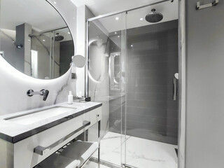 This modern bathroom features a stylish shower along with elegant fixtures and accessories