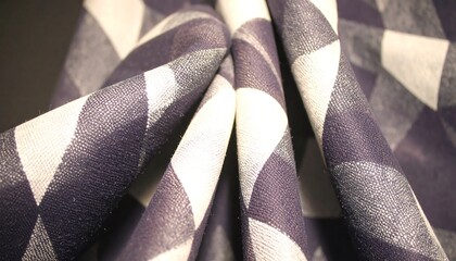 Close-up view of folded fabric with a rich navy blue and off-white checkered pattern.