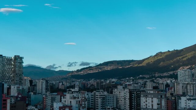 Time-lapse of Panoramic view of the northern part of Quito in the morning with the sun illuminating the buildings - Ecuador