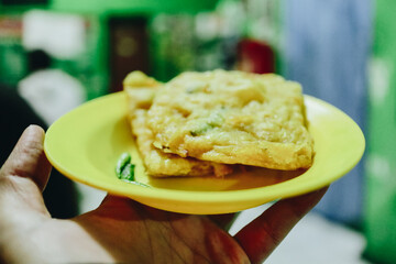 Deliciously Fried Snack Served on a Bright Yellow Plate Amidst a Vibrant Background