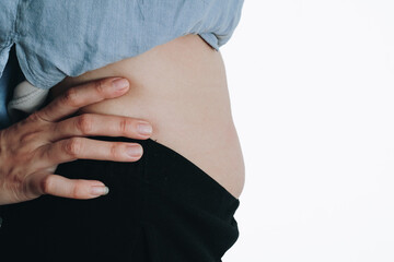 A Detailed Close-Up of a Pregnant Belly Showcasing the Natural Beauty of Expecting Motherhood