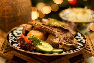 Uzbek lamb shashlik with fresh vegetables on traditional plate copy space, menu