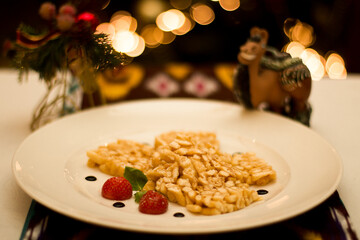 Uzbek cuisine desert Chak chak featuring a beautifully plated dessert with fruits and artistic...