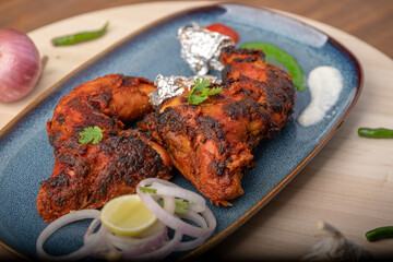 chicken tandoori  with salad served in plate. Tandoori Chicken is an Indian non vegetarian spicy food