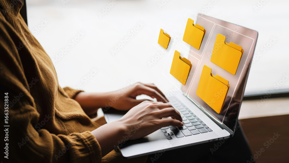 Poster organizing digital files a person using a laptop with holographic folders displayed on the screen fo