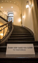 Obraz premium Inspirational quote on a staircase in an elegant interior space