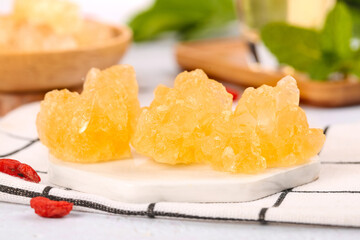 Traditional Yunnan Rock Sugar Cubes - Ancient Handmade Yellow Crystal Sweetener on White Plate