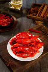 Delicious Red Braised Crayfish with Traditional Chinese Spices on Wooden Table