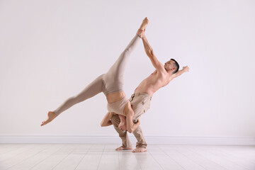 Couple of professional dancers training in studio