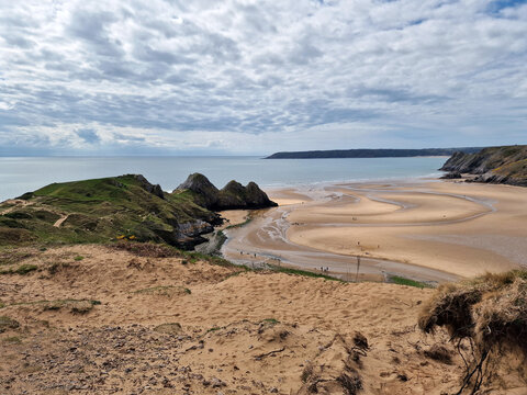 Three Cliffs Bay on the Gower Peninsular West Glamorgan Wales which is a popular Welsh coastline attraction travel destination of outstanding beauty in the UK, vacations stock photo image