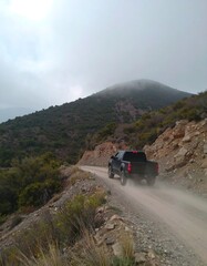 Dusty mountain road with truck