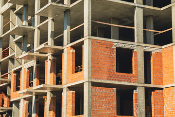 Construction progress of a modern building in an urban area during daylight hours