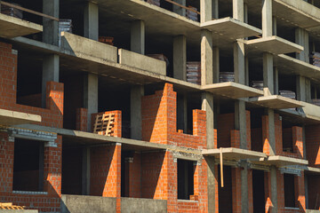 Construction progress of a modern building in an urban area during daylight hours