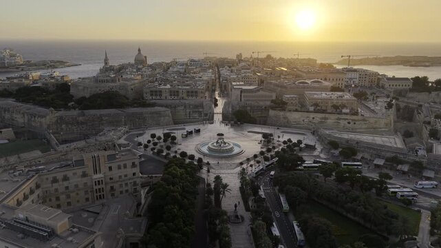 Cinematic wide HDR drone video of Tritons&rsquo; Fountain outside of the Valletta city gates at sunrise in Malta