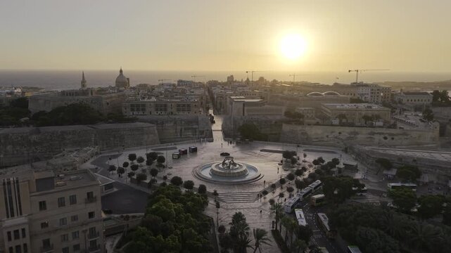 Cinematic HDR 4K drone footage of Valletta, Malta at sunrise - Aerial shot moving forward slowly towards the historic old city