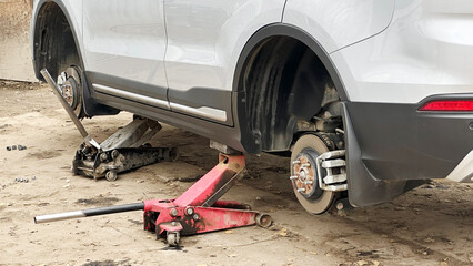 Fototapeta premium Vladimir, Russia, July 24, 2025: A car in tire repair changes summer tires to winter tires