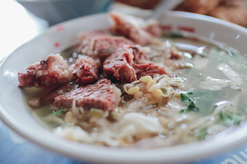 Delicious Bowl of Noodle Soup with Tender Meat and Fresh Herbs, a Culinary Delight