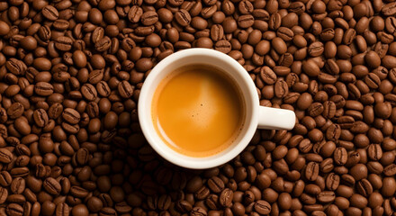 Naklejka premium Top-down shot of glossy Arabica beans with espresso cup and rich crema