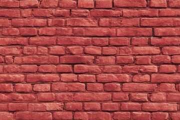 A close-up view of a uniformly textured, deep reddish-brown brick wall. 