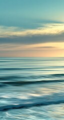 Obraz premium Serene coastal sunset. Soft, horizontal lines of a hazy, pastel sunset over a tranquil ocean. Pastel colors of peach, beige, and teal blend harmoniously. Gentle waves with a blurred motion