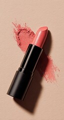 Coral lipstick on a beige background.  A single lipstick, coral shade, sits beside a smear of the same color.  Soft lighting