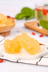 Yellow Rock Candy Crystals Handmade Sugar Confection on White Plate Kitchen Setting