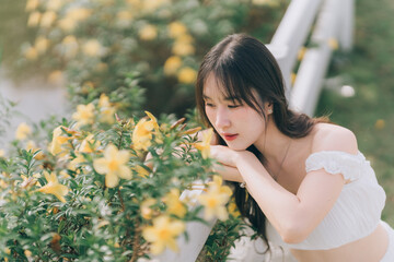 Dreamy Portrait among Yellow Blossoms: A serene woman, embraced by the vibrant hues of yellow...