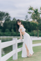Ethereal serenity: A vision of grace and tranquility unfolds as a lady leans elegantly against a...