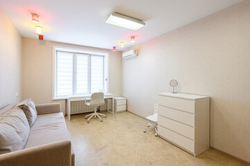bright, minimalist room with a neutral palette. Features a sofa, desk, chest of drawers, window,...