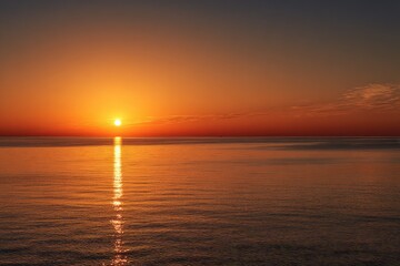 Fototapeta premium Sunrise over calm water, vibrant hues