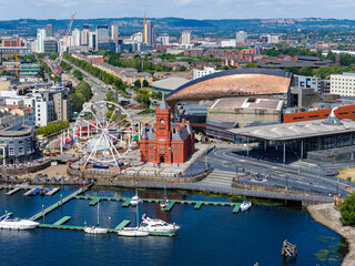 Boats moored in the marina at Cardiff Bay with the Ferris wheel and city behind.