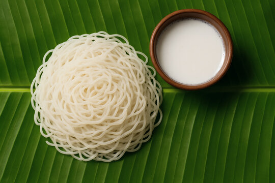 idiyappam South Indian Breakfast Served with Coconut Milk on a Traditional Banana Leaf