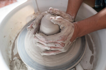 Manos trabajando la ceramica en el torno