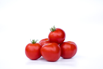 Red ripe tomatoes isolated on white background. Freshness, nutrition, and healthy eating. Fresh ripe tomatoes stacked against white background.