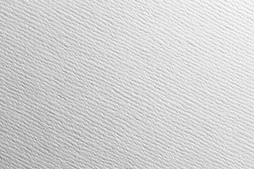 Close-up of textured, white paper surface with subtle, linear ridges
