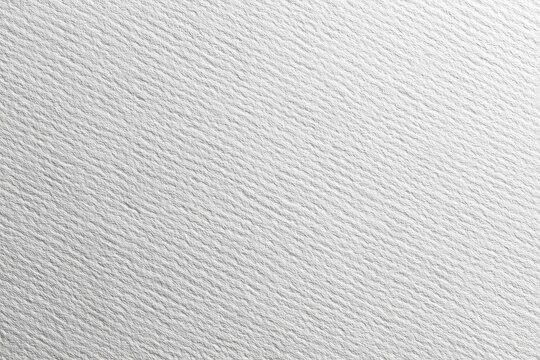 Close-up of textured, white paper surface with subtle, linear ridges