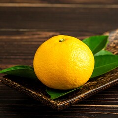 Fresh citrus fruit on wooden tray
