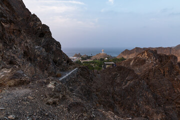 Muttrah, Oman - August ‎5, ‎2025: A panoramic view of Riyam Park and the iconic incense burner monument (Mabkhara) in Muttrah, Muscat, Oman. The image captures the coastline, lush greenery. 