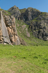 Mountain landscape against a bright blue sky.